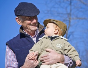Granfather holding grandson