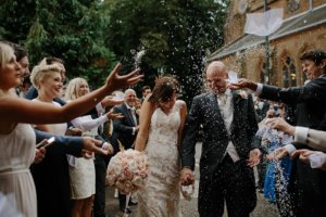 People throwing rice at Bride and grrom