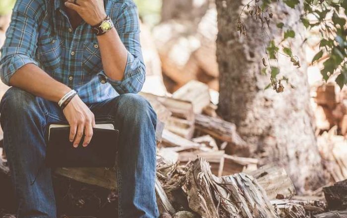 Man Sitting on log
