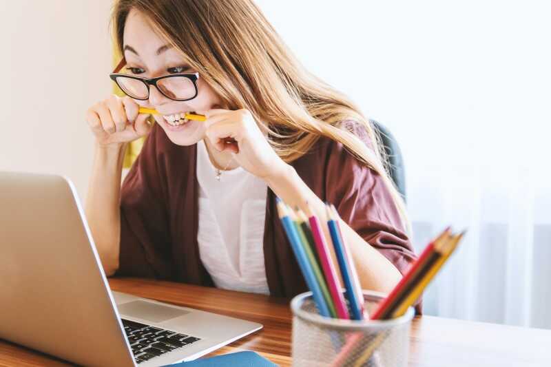 Women Chewing on Pen